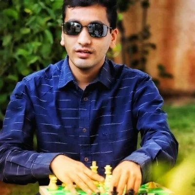 Visually impaired chess player Darpan Inani shows his opponents he