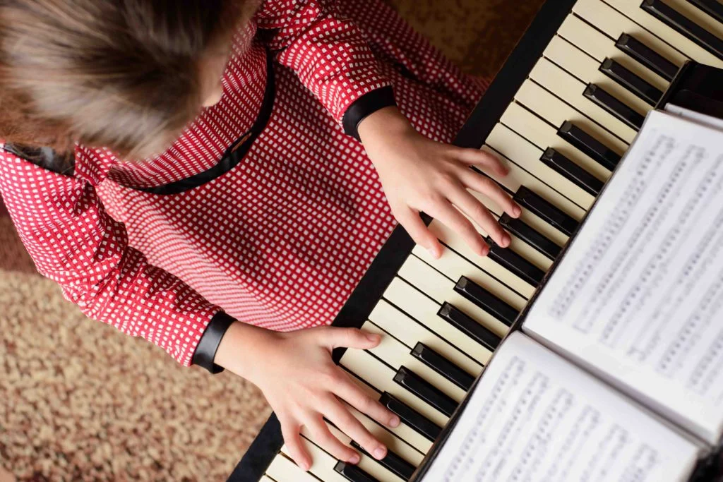 top-view-young-girl-playing-piano-home-1024×683.jpg